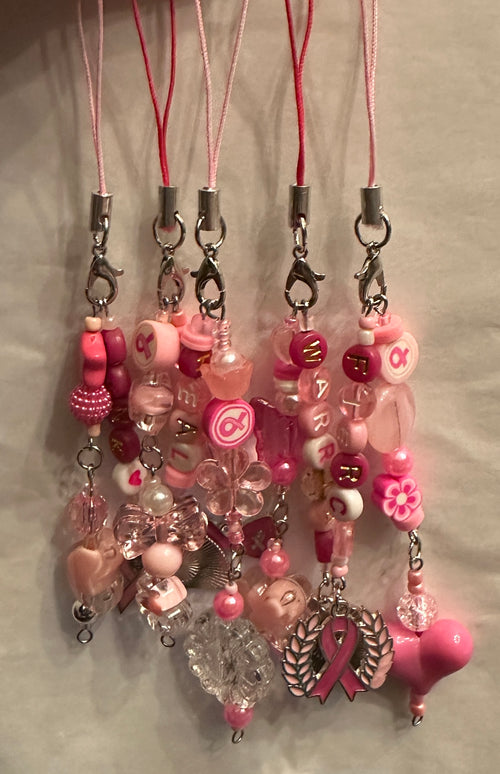 Pink beaded phone strap charms with silver lobster clamps, pink or magenta lanyards.